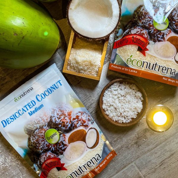 A bag of Econutrena's desiccated coconut with coconut flakes scattered around, showcasing premium, organic quality.